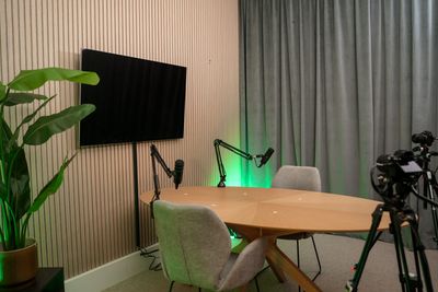 Professional podcast studio with table and microphones